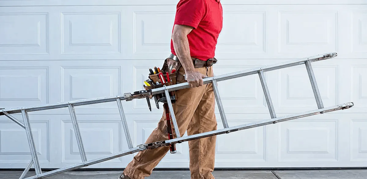 Garage door repair technician arriving with tools and ladder in Detroit, MI