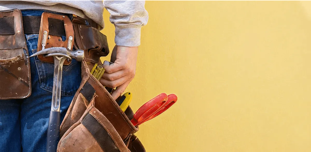 Handyman with tool belt ready for home repairs and maintenance in Detroit, MI