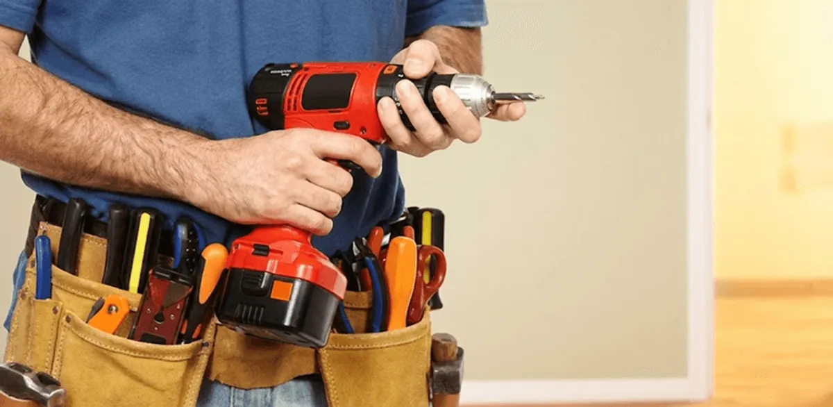 Handyman holding a power drill for home repairs and installations in Detroit, MI